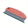 A pink and gray gentle pet hair removal brush for cats and dogs.