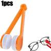 An orange microfiber tool used for cleaning eyeglasses is shown next to a pair of glasses.