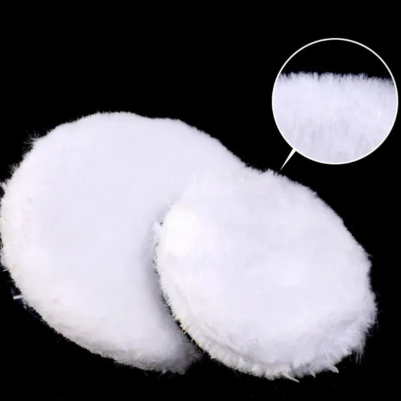 A set of white wool polishing discs for car detailing.