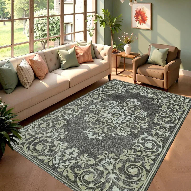 A rectangular gray and cream cowhide print area rug placed in a bright living room with a sofa and potted plants.