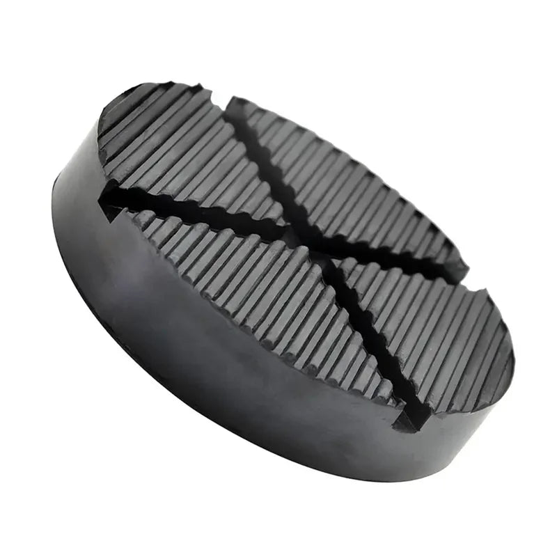 A black rubber jack pad with a textured surface used for car pinch welds.
