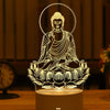 A glowing silhouette of a meditating Buddha in a lotus pose is displayed on a wooden surface.