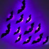 A cluster of black bat silhouettes with purple LED glow against a dark background.