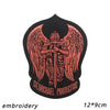 A black embroidered patch featuring a stylized archangel with wings and the text St. Michael Protectus.