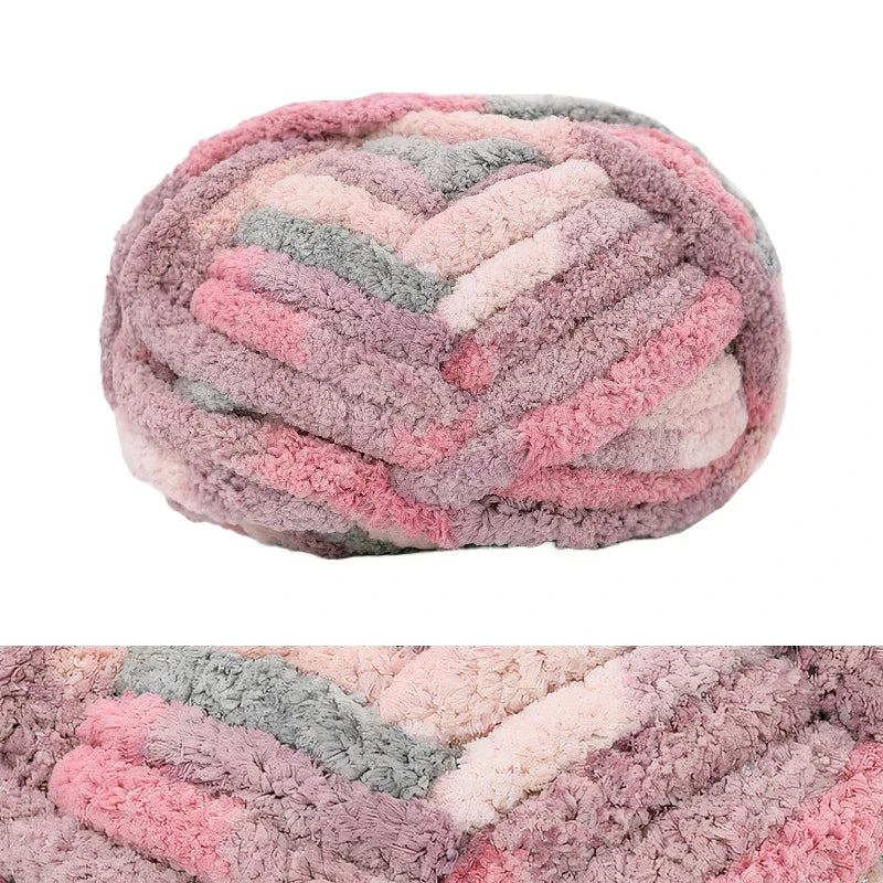 A ball of chunky chenille yarn in shades of pink, purple, and gray.