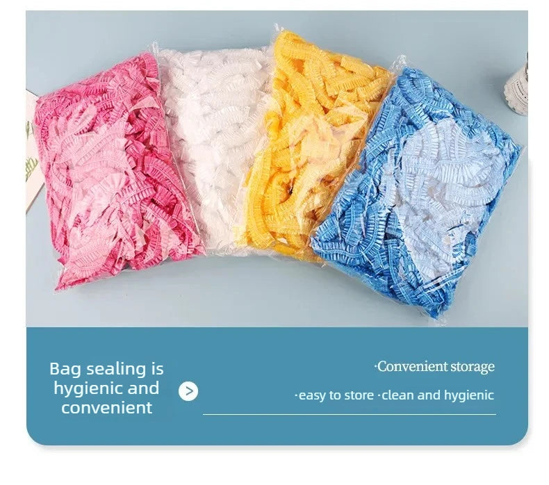 A display of colorful disposable transparent waterproof shower caps in pink, white, yellow, and blue.