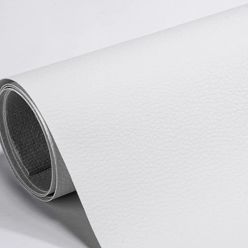 A roll of white self-adhesive PU leather repair patches is shown, rolled up and partially unrolled.