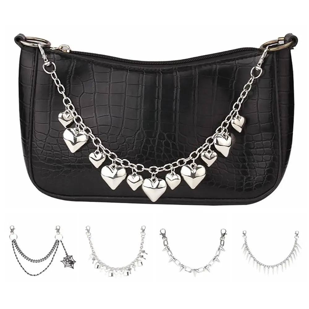 Black crocodile print handbag with a silver chain strap and decorative charms