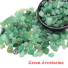 Green aventurine crystal stone chips scattered on a dark bowl
