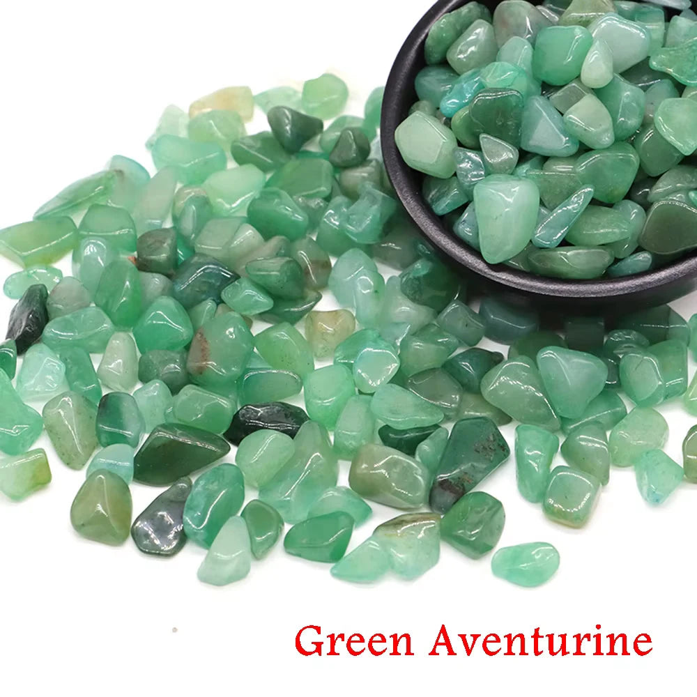 Green aventurine crystal stone chips scattered on a dark bowl
