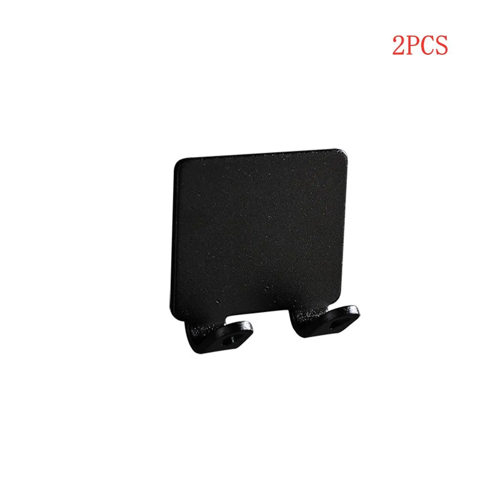 Two black aluminum wall-mounted adhesive razor holders.