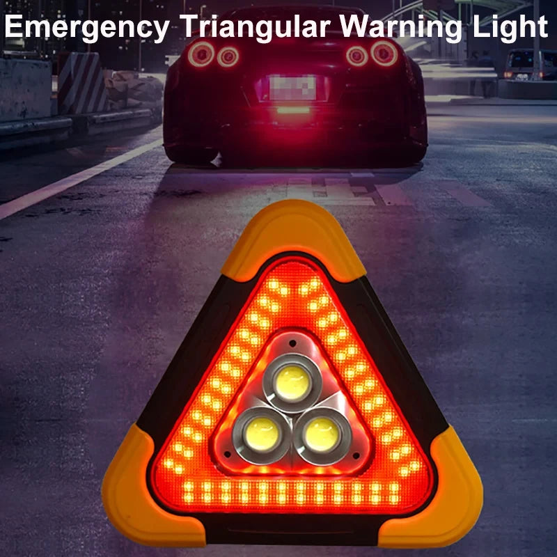 A close-up view of an emergency triangular warning light with three LED lights and a flashlight, set on an asphalt road.