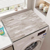 A white wood grain waterproof washer and dryer mat placed on a countertop next to a window.