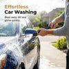 A person is using a high pressure power washer nozzle to clean the exterior of a dark blue car.