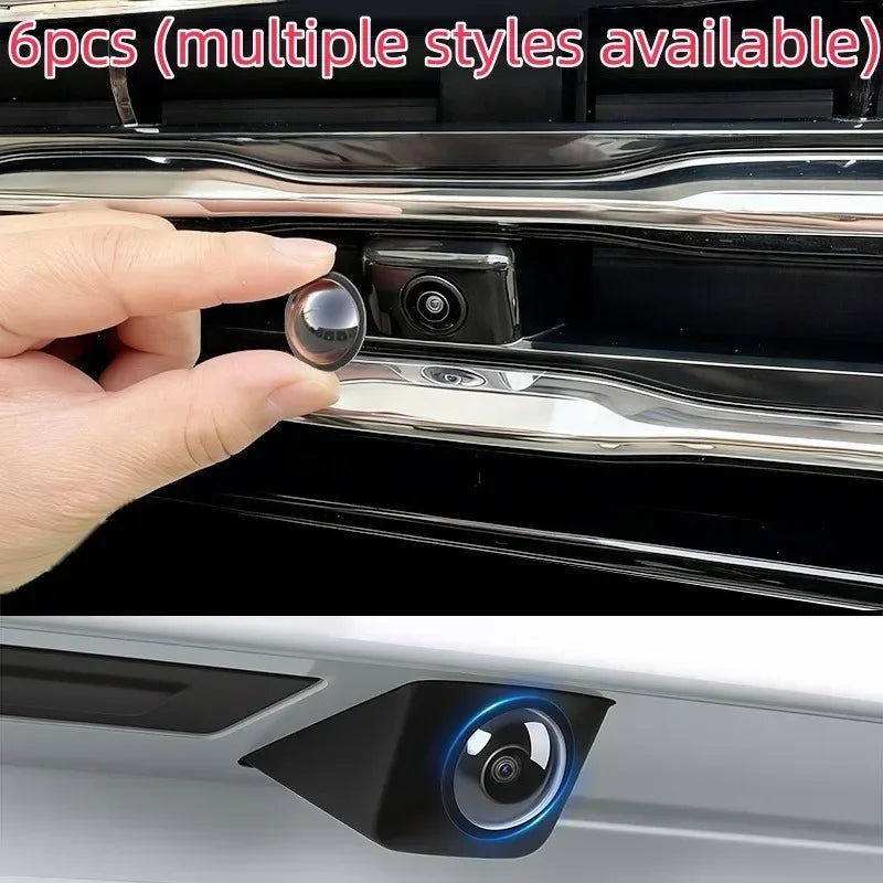 A hand is holding a protective cover for a car camera, showing the camera lens and surrounding housing.