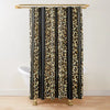 A shower curtain featuring a vertical pattern of leopard print and black stripes hanging from a gold rod.