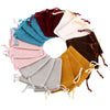 A circular arrangement of velvet drawstring jewelry pouches in various shades including teal, pink, maroon, brown, and mustar