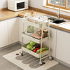 A white 3-tier rolling metal storage cart filled with various kitchen items on a countertop.