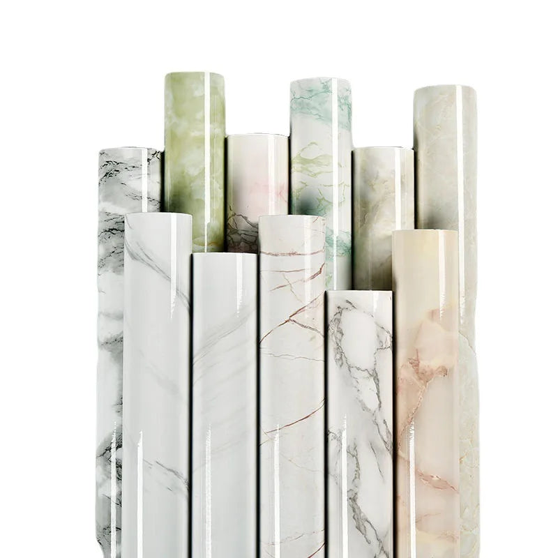 A collection of vertical marble contact paper rolls in various shades of green, pink, and white.