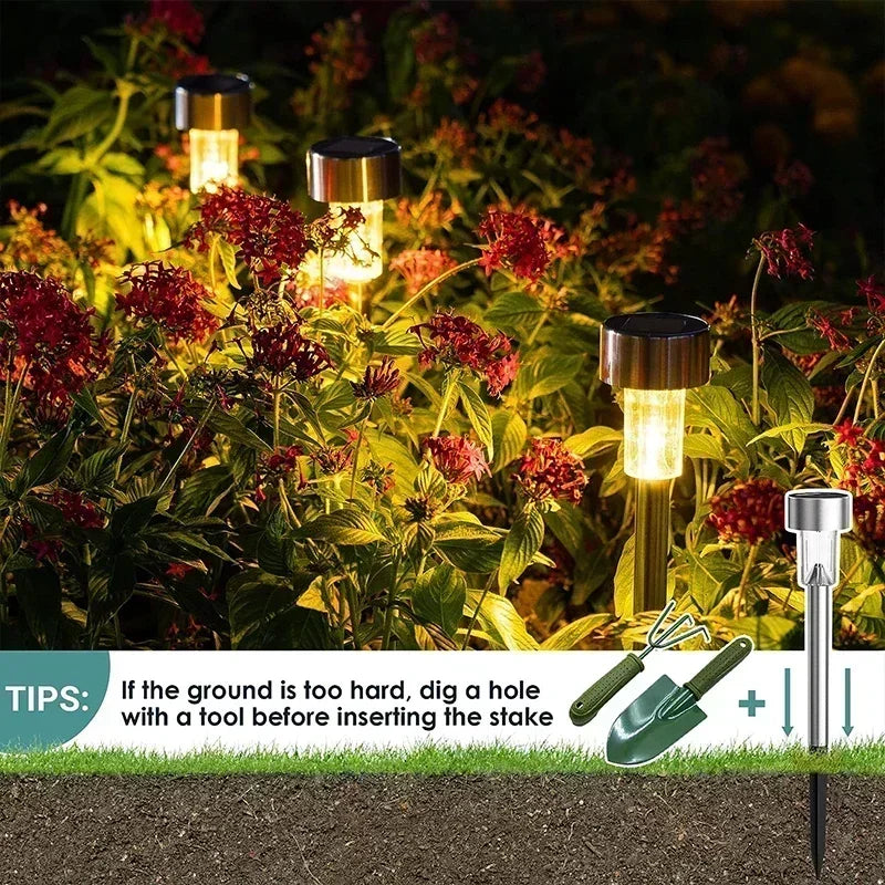 A set of ten solar-powered garden path lights illuminating red foliage in a garden setting.