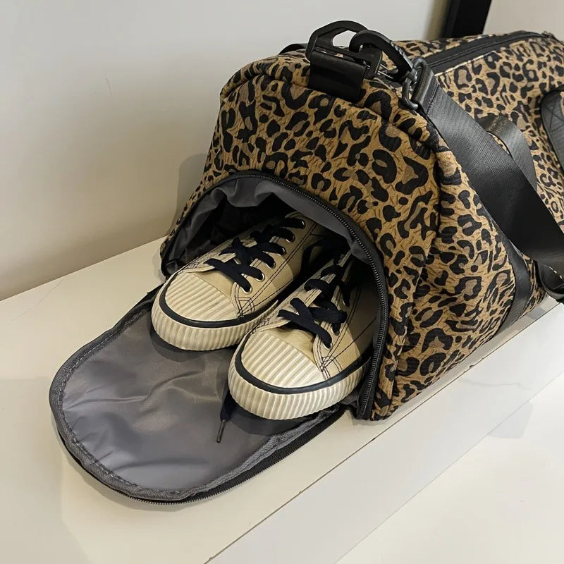 A leopard print weekender tote bag with a shoe compartment is shown lying on a white surface.