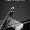 A magnetic phone ring holder and kickstand is shown mounted on a car grille.