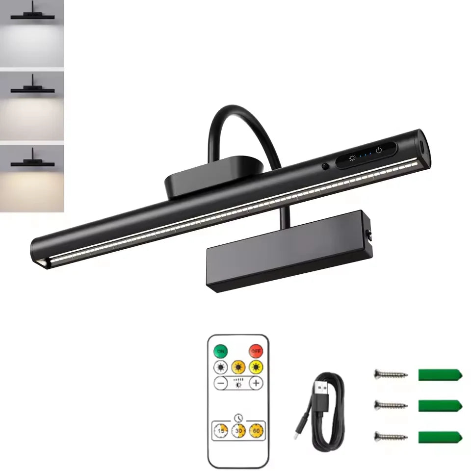 A black cordless rechargeable picture light with a remote control and battery visible against a white background.