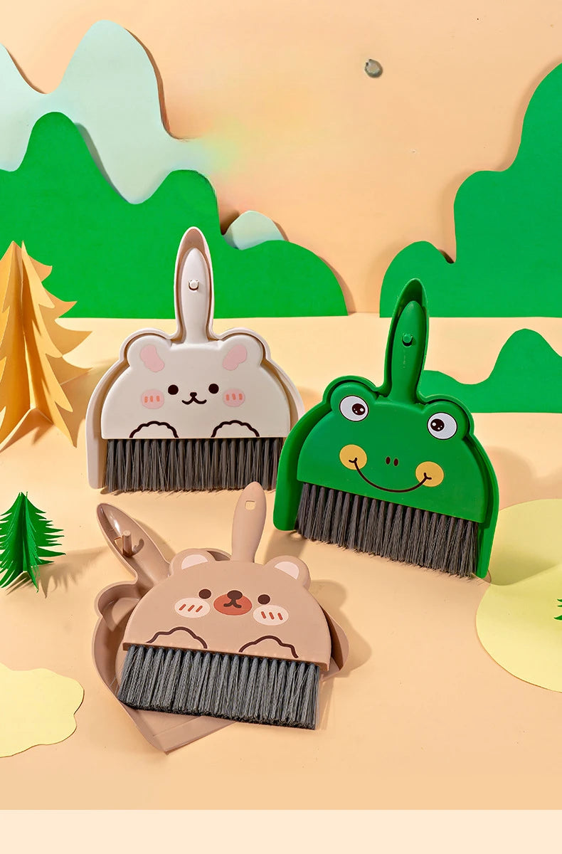 A set of three compact cartoon brooms and a dustpan featuring woodland animal designs on a light wooden background.