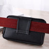 Black PU leather waist bag with a red strap resting on a wooden surface.