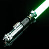 A close-up view of a Bluetooth motion-controlled lightsaber with a metal hilt and glowing green blade against a black backgro