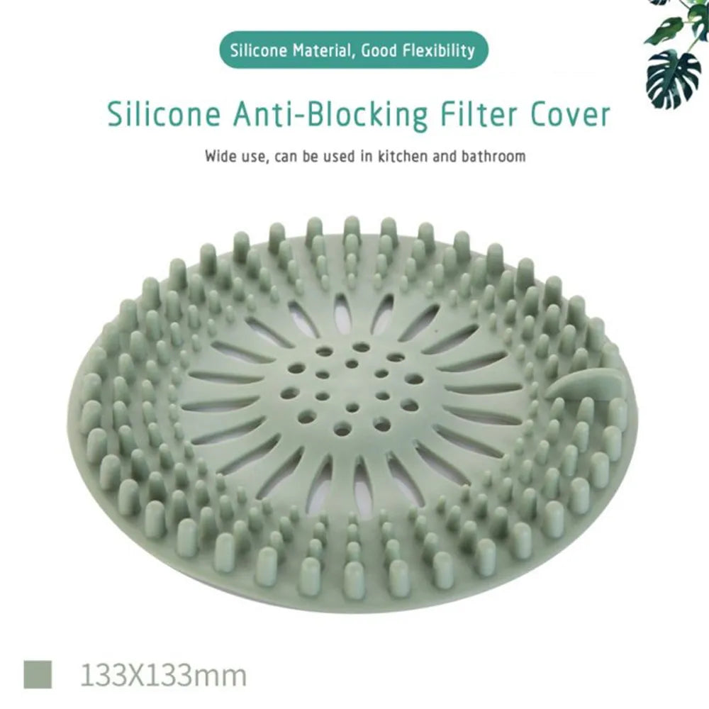 A round, light green silicone anti-blocking filter cover used for draining hair in kitchens and bathrooms.