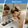 A woman is using a diatomite faucet mat in a kitchen sink and bathroom basin to absorb water.