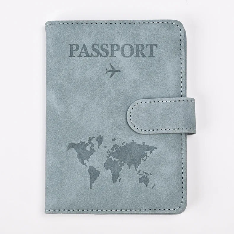A light gray leather passport holder featuring a world map and an airplane icon.