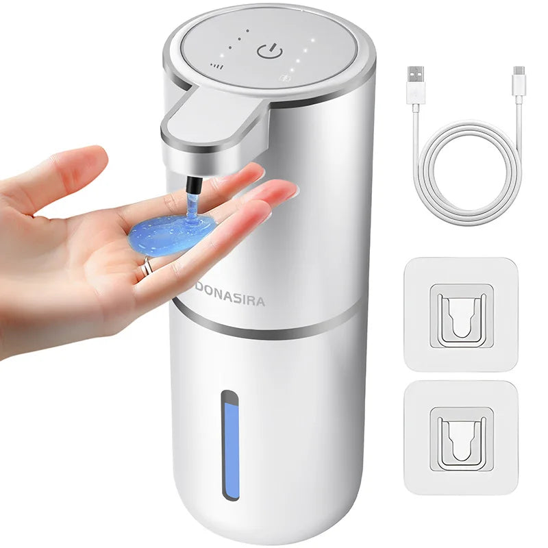 A white touchless automatic soap dispenser is shown being used by a hand, with charging cable and dispensing icons displayed.