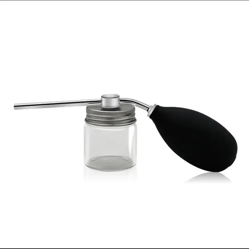 A silver and black refillable spray bottle with a long applicator for precision styling.