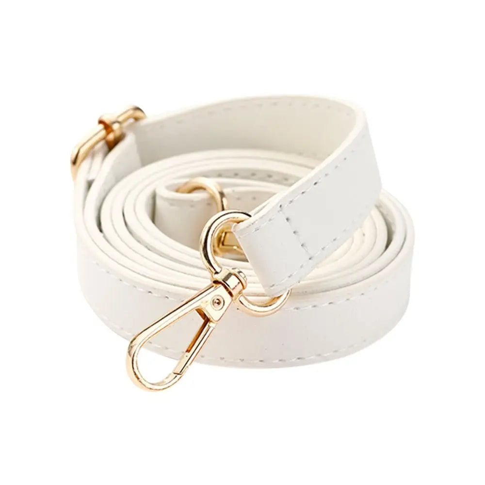 A white leather bag strap replacement with a gold-toned buckle and clip, coiled for display.