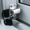 A silver sliding door window lock mechanism with a key and a separate key are shown against a white frame.