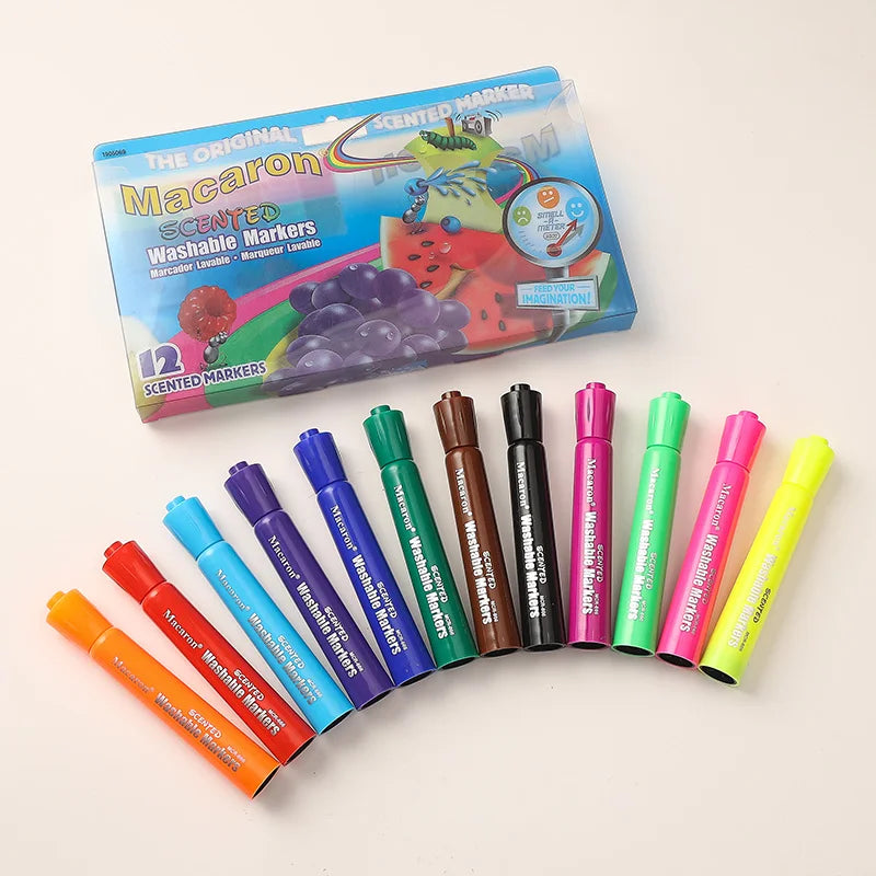 A collection of twelve washable scented markers in assorted fruit colors, including red, purple, and yellow, displayed next t