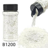 A glass jar of B1200 nail glitter mix with a black shaker top next to a pile of white glitter.