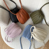A collection of elegant pleated faux leather crossbody bags in shades of black, terracotta, olive green, mauve, blue, and cre