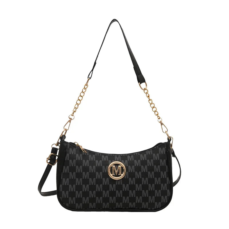 Black PU leather crossbody bag with a gold chain strap and a metal M accent.