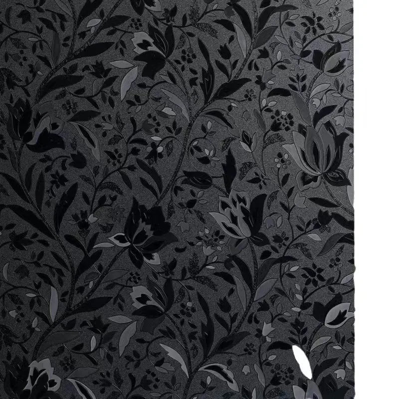 Dark gray floral pattern of elegant tulips and leaves on a window film.