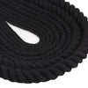 A close-up of black natural twisted cotton cord coiled into a thick rope.