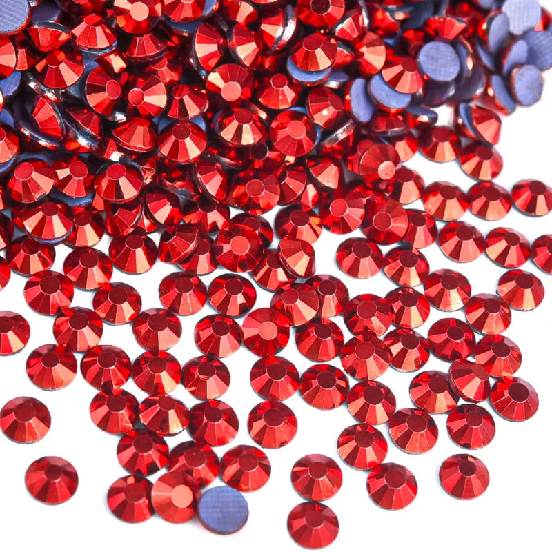 A pile of red and blue hotfix rhinestones for DIY crafts and clothing decoration.