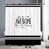 A white shower curtain featuring black horizontal stripes and the text Be Awesome today and everyday.