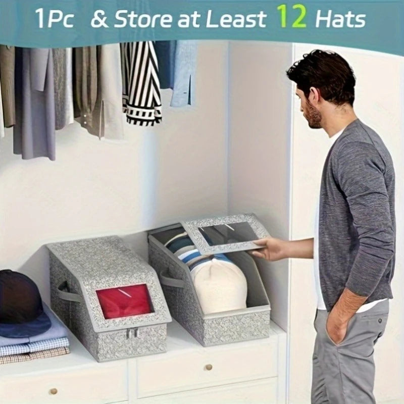 A man is storing hats in a gray fabric storage box inside a closet shelf.