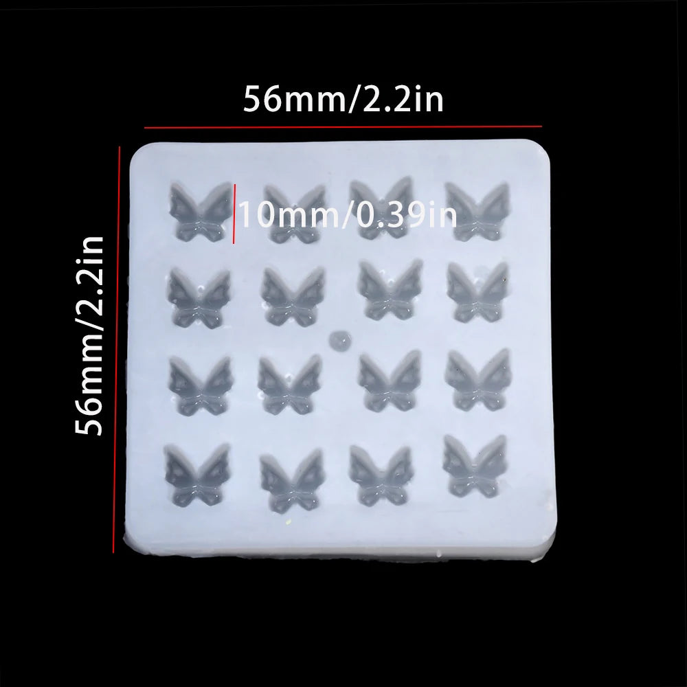 A white epoxy resin mold with multiple butterfly-shaped cavities for DIY jewelry making.