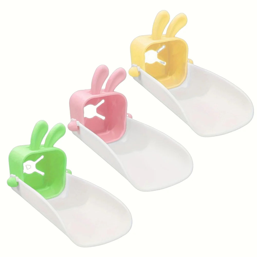 Three plastic rabbit-themed anti-splash faucet extenders in yellow, pink, and green.