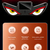 Close-up of a red car window decal featuring a black demon eye design with yellow and red accents.