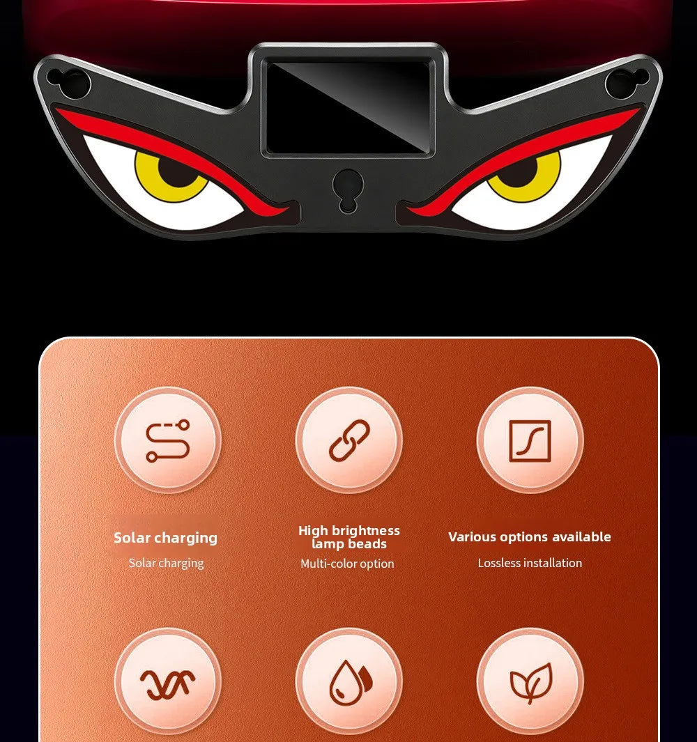 Close-up of a red car window decal featuring a black demon eye design with yellow and red accents.